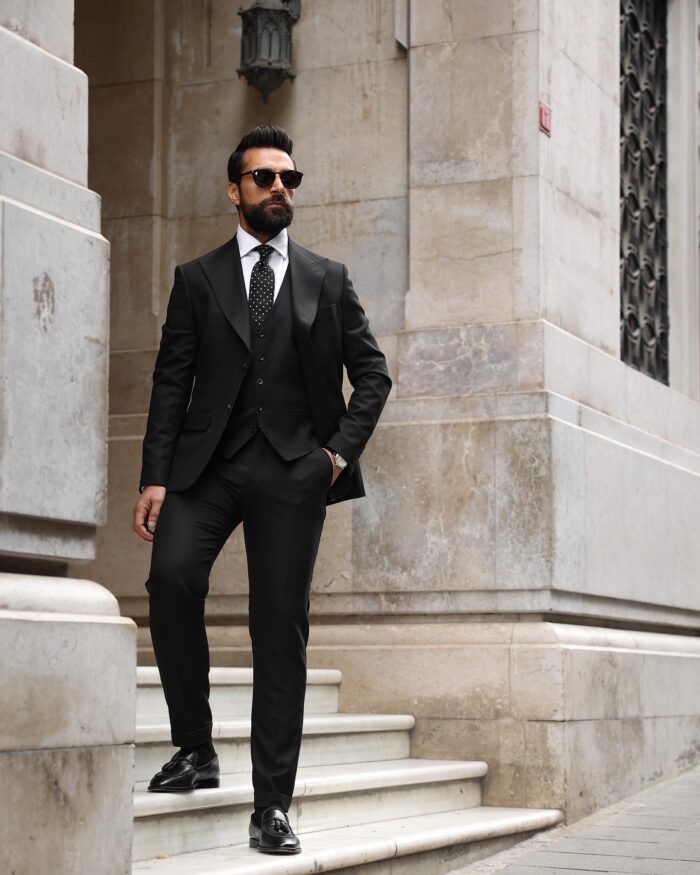 Minerva Walk <p>Slim fit all black three piece men’s suit with peak lapels</p>