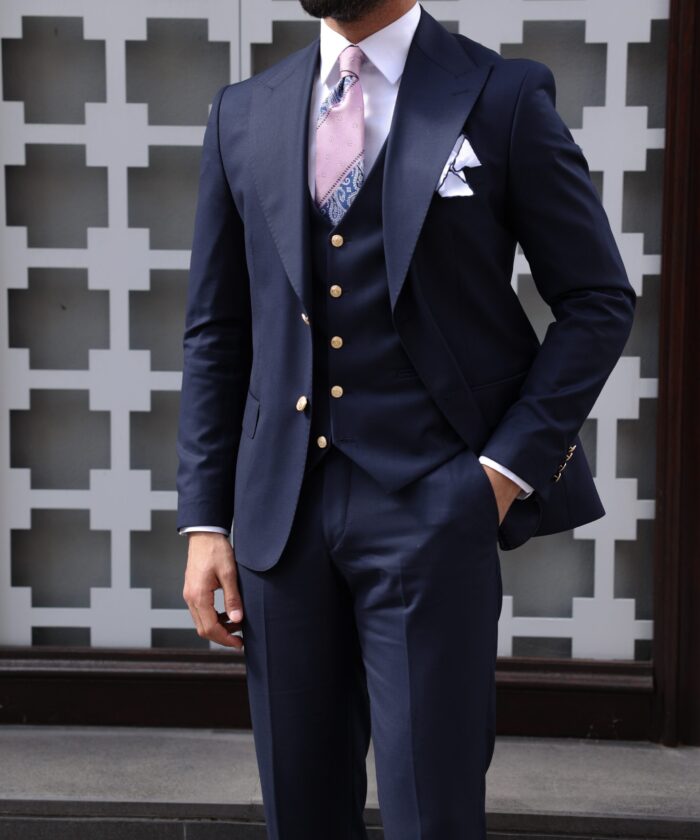 Clifton Villas <p>Slim fit dark blue men’s three piece suit with decorative gold buttons and peak lapels</p>