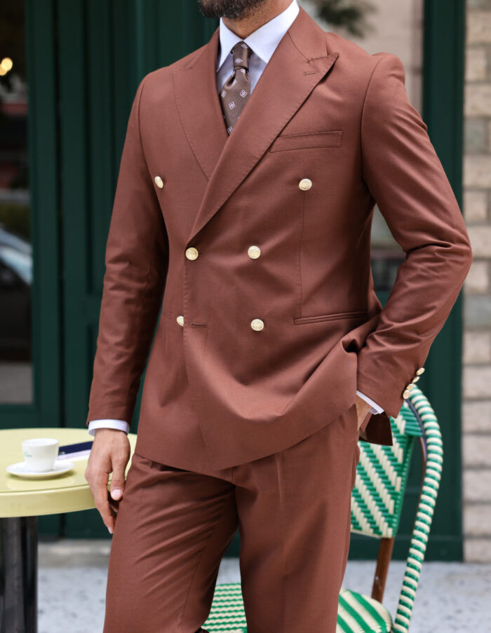 Hethering Street Tailored slim fit toasted brick double breasted men's suit with peak lapels with decorative gold buttons.