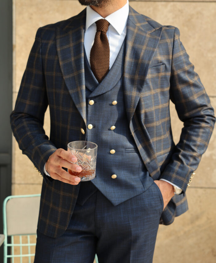 Hoppers Lane Slim fit dark blue chequered mixed three piece suit with a double breasted waistcoat and peak lapels with decorative gold buttons