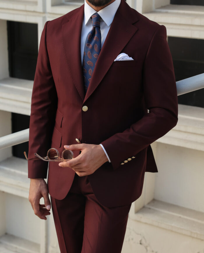 Mead Lane Tailored slim fit crimson red men's two piece suit with peak lapels with decorative gold buttons.