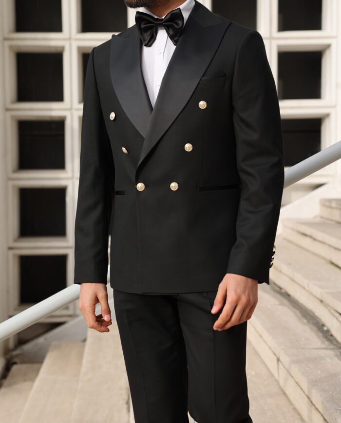 Prince Wesley Slim fit all black double breasted two piece men's tuxedo suit with peak satin lapels WITH DECORATIVE GOLD BUTTONS.